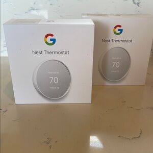 2 Google Nest Thermostats in White